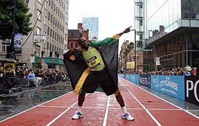 Olympic sprinter Usain Bolt celebrates after winning the final of the 150 metres sprint at the Citygames in Manchester. Bolt ran the fastest ever 150m on Sunday in a street race held in a chilly and windy Manchester City Centre.(AFP/Andrew Yates) 