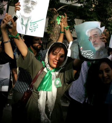 Supporters of Iranian presidential hopeful Mir Hossein Mousavi, former Prime Minister, hold posters of Mousavi during a presidential election campaign in Teheran, capital of Iran, June 8, 2009. Thousands of backers of Mousavi formed a human chain here on Monday to support him in the presidential elections on June 12.(Xinhua/Ahmad Halabisaz)