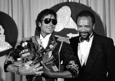 With Quincy Jones at his side, Michael Jackson holds six of the eight awards he won for "Thriller" at the 1984 Grammy Awards. His outfit, complete with epaulets, sequined glove and dark shades, became a quintessential Michael look.