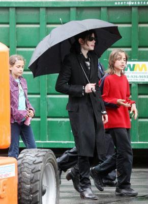 Michael Jackson walks with kids Prince and Paris through a studio parking lot in Los Angeles in March 2009. The singer had been spotted with his entourage going to a studio on a cold rainy day in the city. The pop star stayed at the studio for more than two hours, and there were many production people working around him, suggesting that the star was filming.