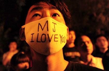 Young Chinese mourn the death of Michael Jackson in Beijing on Friday. The death of Michael Jackson gripped China, as fans spoke of how his music became the soundtrack for the nation's early years of opening to the outside world nearly 30 years ago. 