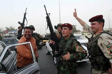 Iraqi civilians and security celebrate on the streets of the southern city of Basra, some 550 kms from the capital Baghdad, as US troops withdraw from Iraqi towns and cities across the nation.(AFP/Essam al-Sudani)