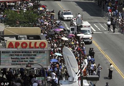 Fans line up outside the Apollo Theatre to pay their respects