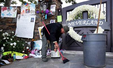 A worker at the Neverland Ranch in Los Olivos, where new double wreaths of 1,200 white roses and 300 white orchids were hung on Wednesday