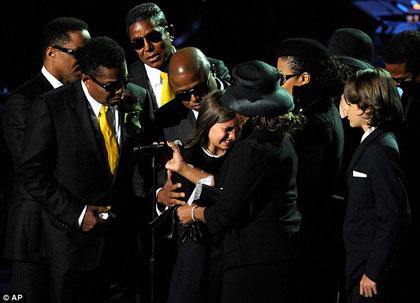 Breaking down: Paris cries after paying tribute to her father Michael Jackson at his memorial concert, surrounded by his family; (L to R) Marlon, Tito, Jermaine, Randy, Paris, Rebbie, Janet and Prince Michael 