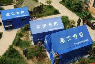 Photo taken on July 11, 2009 shows the tents built for displaced people at Guantun Village, in Yao'an County, Chuxiong Ethnic Yi Autonomous Prefecture in southwest China's Yunnan Province. A total of over 3000 tents have been built up for local people who suffered the 6.0-magnitude earthquake in Yao' an on Thursday. Now more than 20,000 earthquake victims have been placed in tents and have received basic relief materials.(Xinhua/Lin Yiguang)