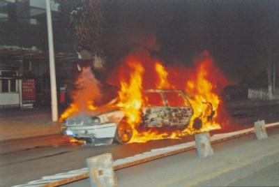File photo released by the government of Urumqi City in a press conference in Urumqi, capital of northwest China's Xinjiang Uygur Autonomous Region, shows a burnt car in the riot happened on July 5, 2009. (Xinhua Photo)