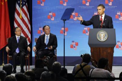 China's State Councillor Dai Bingguo (L) and China's Vice Premier Wang Qishan (C) listen as US President Barack Obama addresses the opening of the first joint meeting of the China-US Strategic and Economic Dialogue in Washington July 27, 2009. [Agencies]