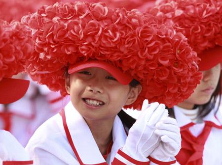 A student smiles while attending the celebrations for the 60th anniversary of the founding of the People's Republic of China on the Tian'anmen Square in central Beijing, capital of China, Oct. 1, 2009.(Xinhua/Pang Xinglei)