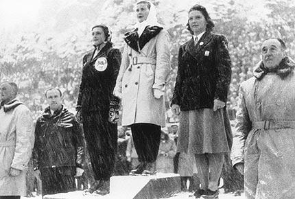 St Moritz, 8 February 1948, Olympic stadium: medal ceremony for women's figure skating event: (L-R) Jeannette ALTWEGG from Great Britain, 3d, Barbara-Ann SCOTT from Canada, 1st, and Eva PAWLIK from Austria, 2d. Credit: IOC Olympic Museum Collections