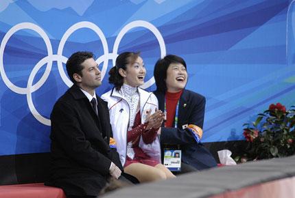 Turin, Palavela, 21 February 2006, XX Olympic Winter Games. Women's figure skating: Japanese Shizuka ARAKAWA, surrounded by her coach Nikolay Morozov and Kumiko Sato, is delighted about her results in the kiss-and-cry area. Credit: IOC/Yo Nagaya