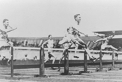 Amsterdam, August 1928: David BURGHLEY from Great Britain (on the left), 1st, in action in the 400m hurdles. Credit: IOC Olympic Museum Collections