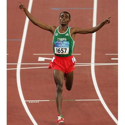 Athens, Olympic Stadium, 20 August 2004, Games of the XXVIII Olympiad. Men's athletics: Kenenisa BEKELE of Ethiopia celebrates winning. Credit: Getty Images/Mark Dadswell