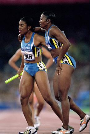 Sydney, 29 September 2000, Games of the XXVII Olympiad. Women's athletics: Debbie FERGUSON (L) and Pauline Elaine DAVIS of the Bahamas get their breath back after winning the 4x100 relay semifinal. Credit : Getty Images/Stu Forster