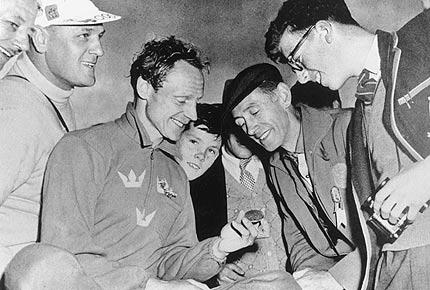 Melbourne 1956, Games of the XVI Olympiad. Swede Gert FREDRIKSSON, 1st in the 10000m and 1000m flatwater kayak events, shows one of his medal to the admiring public. Credit: IOC Olympic Museum Collections