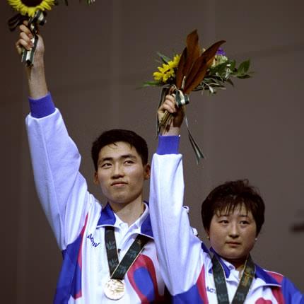 Atlanta, Georgia State University, 1 August 1996, Games of the XXVI Olympiad: medal ceremony for the badminton mixed doubles: Dong-Moon KIM and Young-Ah GIL from Korea, gold medallists. Credit: Getty Images/Stu Forster