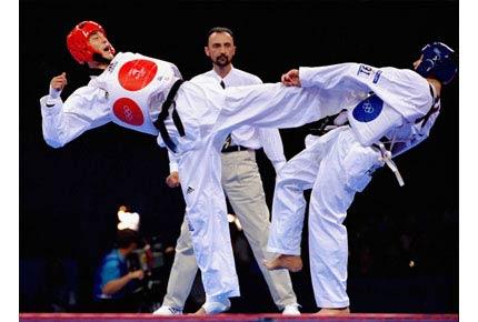 Sydney, State Sports Centre, Olympic Park, 30 September 2000, Games of the XXVII Olympiad: Kyong-Hun KIM of Korea (in red) in action against Daniel TRENTON of Australia in the +80kg taekwondo final. KIM went on to win the gold medal. Credit: Getty Images/Robert Cianflone