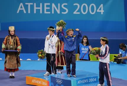 Athens, 23 August 2004, Games of the XXVIII Olympiad. (L to R) Chiharu ICHO of Japan (silver), Irini MERLENI of Ukraine (gold) and Ang岢lique BERTHENET (bronze) of France receive their medals during the medal ceremony for the women's -48kg freestyle wrestling event at Ano Liossia Olympic Hall. Credit: Getty Images/Stuart Franklin