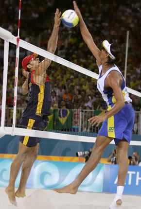 Athens, 17 August 2004, Games of the XXVIII Olympiad. Men's beach volleyball: Ricardo Alex SANTOS of Brazil spikes the ball past Joshua SLACK of Australia during the preliminary round at the Faliro Coastal Zone Complex. Credit: Getty Images/Ian Waldie
