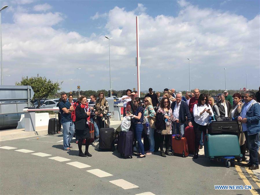 Passengers wait for a bus to Paphos at the Larnaca airport in Larnaca, Cyprus, March 29, 2016. The women and children on a hijacked Egyptian plane have been released after it landed in Larnaca, Cyprus, Cypriot authorities said Tuesday. Larnaca airport has been closed and arriving planes are being redirected to Paphos in western Cyprus. (Xinhua/Zhang Zhang) 