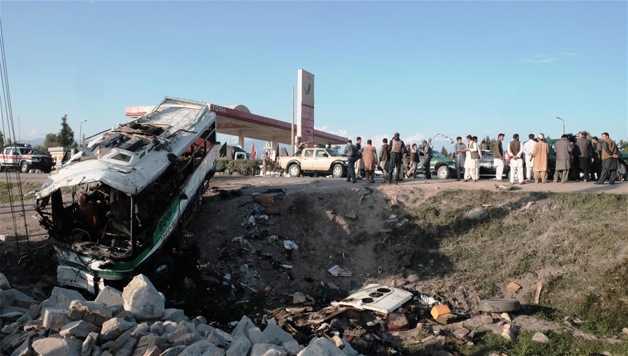 Photo taken on April 11, 2016 shows a destroyed bus at the site of a suicide attack in Nangarhar province, eastern Afghanistan. At least 12 people were killed and more than 20 others wounded after a suicide bomber targeted a police academy vehicle in Afghanistan