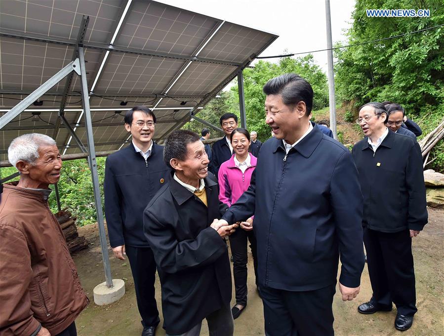 Chinese President Xi Jinping (R front) inspects the solar power station installed under a poverty alleviation project in Dawan Village of Huashi Township in Jinzhai County, Liuan City, east China