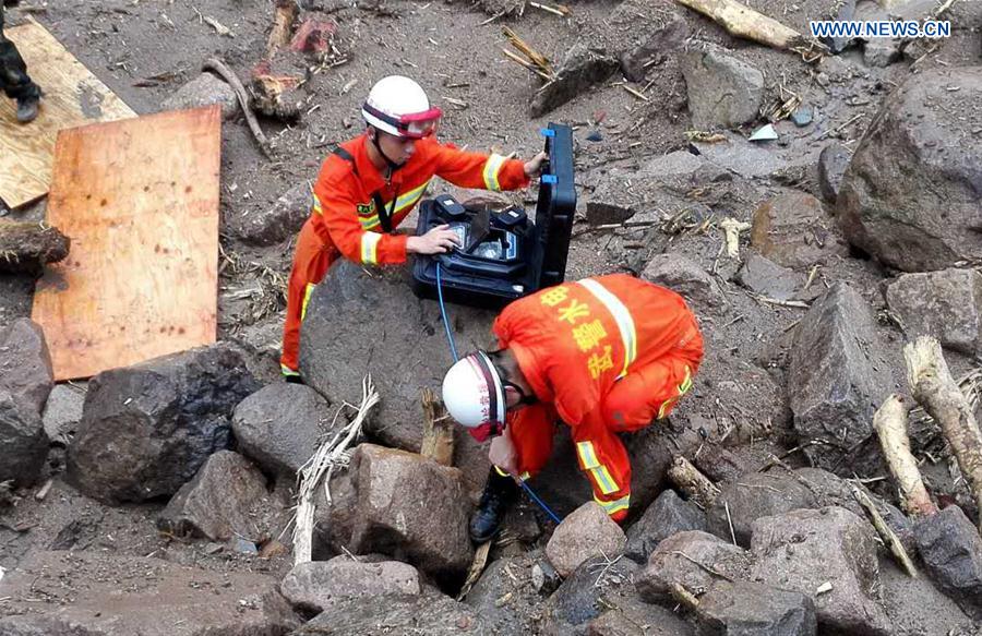 SANMING, May 8, 2016 (Xinhua) -- Rescuers search for signs of life at the landslide site in Taining County, southeast China