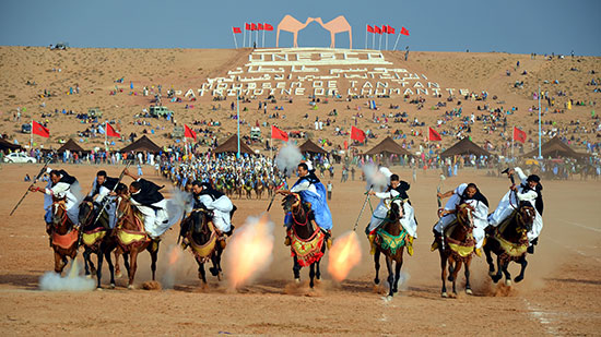 Sahrawi tribal men performing the fantasia at the Tan-Tan Moussem in Tan-Tan, Morocco.