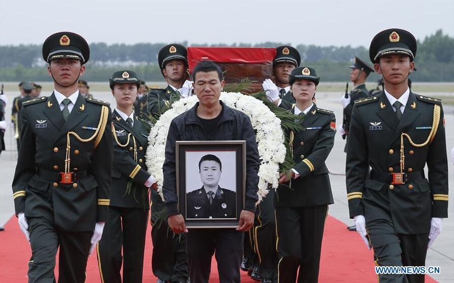 CHANGCHUN, June 9, 2016 (Xinhua) -- Shen Mingming (C), elder brother of Chinese UN peacekeeping soldier Shen Liangliang, escort the coffin of Shen Liangliang to the hearse at Longjia Airport in Changchun, capital of northeast China