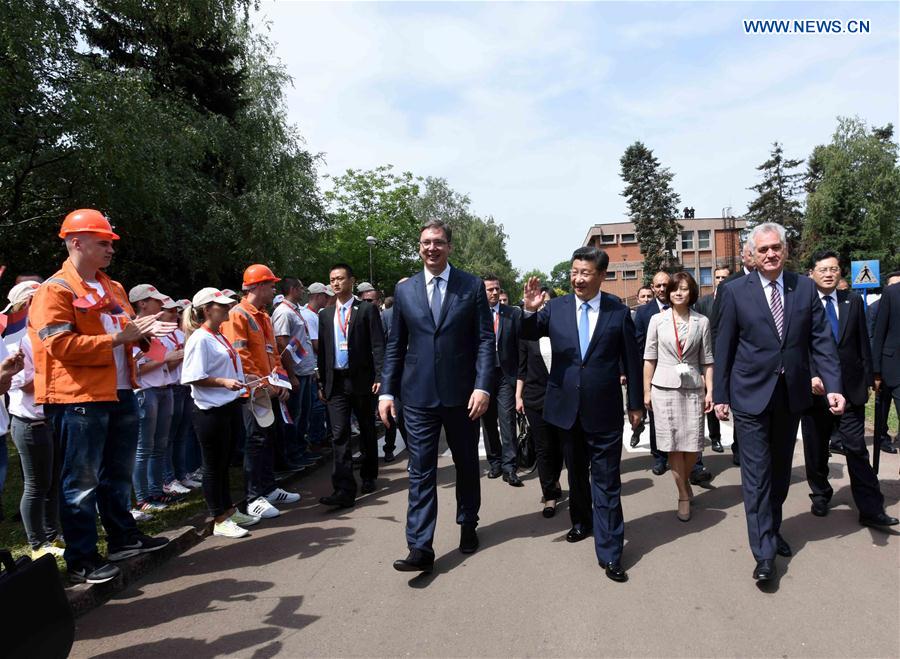 Chinese President Xi Jinping (2nd R, front), accompanied by Serbian President Tomislav Nikolic (1st R, front) and Serbian Prime Minister Aleksandar Vucic (3rd R, front), is welcomed by workers, their families and local citizens as he visits Serbia