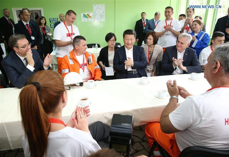 -- Chinese President Xi Jinping (C), accompanied by Serbian President Tomislav Nikolic and Serbian Prime Minister Aleksandar Vucic, talks with workers at the dining hall of a steel mill in Smederevo, Serbia, June 19, 2016. Xi paid a visit on Sunday to Serbia