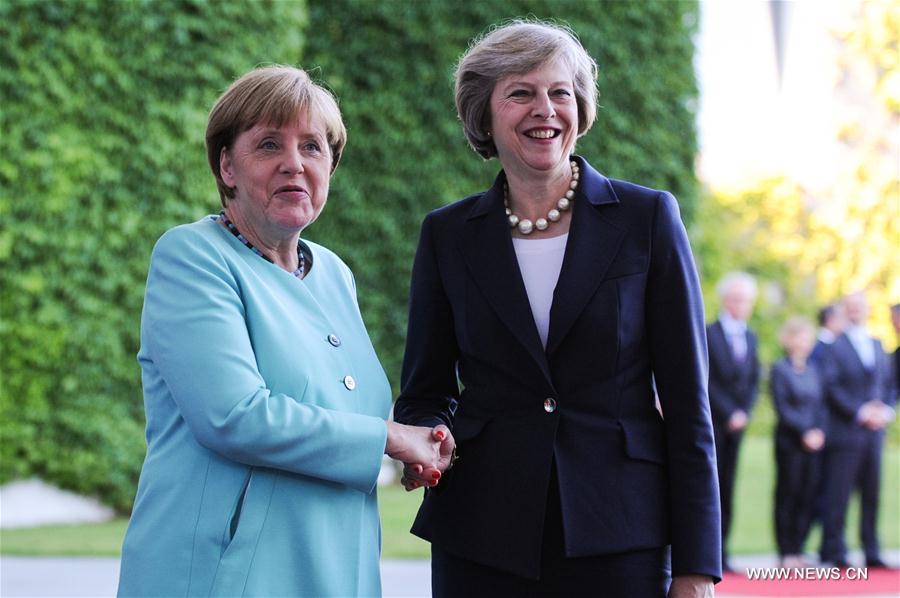 German Chancellor Angela Merkel(L) and British Prime Minister Theresa May attend a welcoming ceremony prior to their meeting at the Chancellery in Berlin, Germany, on July 20, 2016. Britain will maintain close economic relations with Germany despite its intention to exit the European Union (EU), Britain