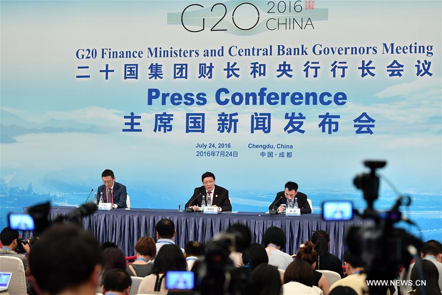 Chinese Finance Minister Lou Jiwei (C back) speaks at the press conference of G20 finance ministers and central bank governors meeting in Chengdu, capital of southwest China