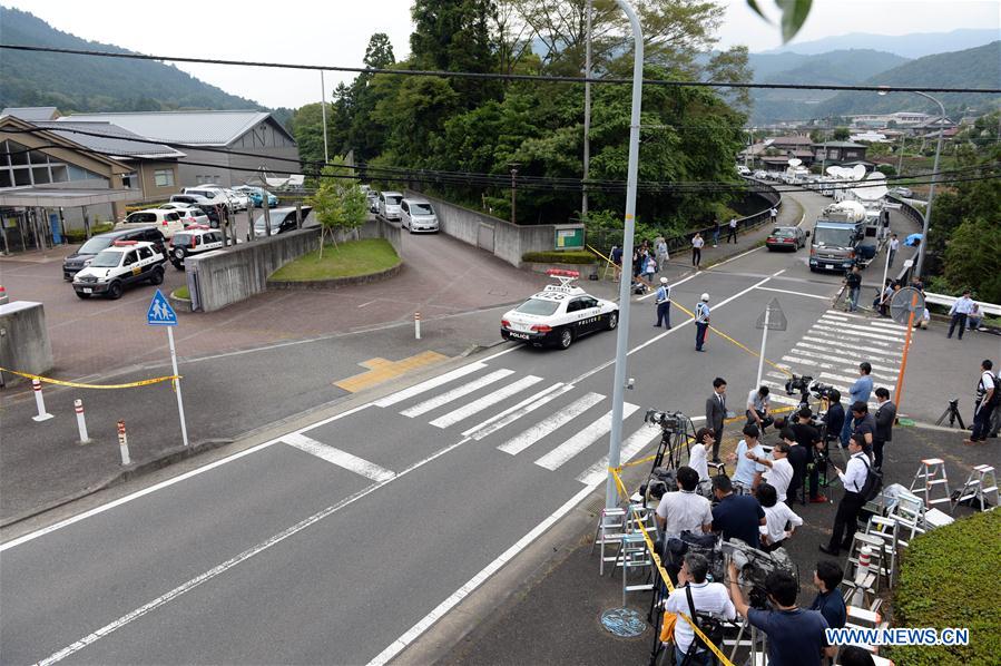 Reporters gather outside of the Tsukui Yamayuri-en (Tsukui Lily Garden) care facility in Sagamihara City, Japan