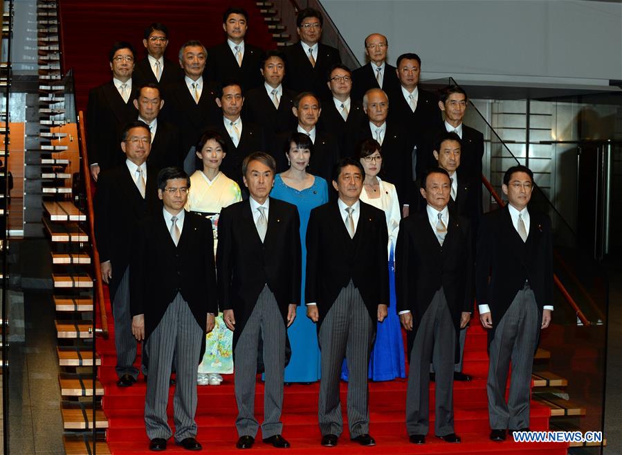 Japanese Prime Minister Shinzo Abe (C, Front) and cabinet ministers pose during a photo session at Abe