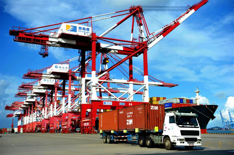 A truck transfers containers at Qingdao port in Qingdao, east China