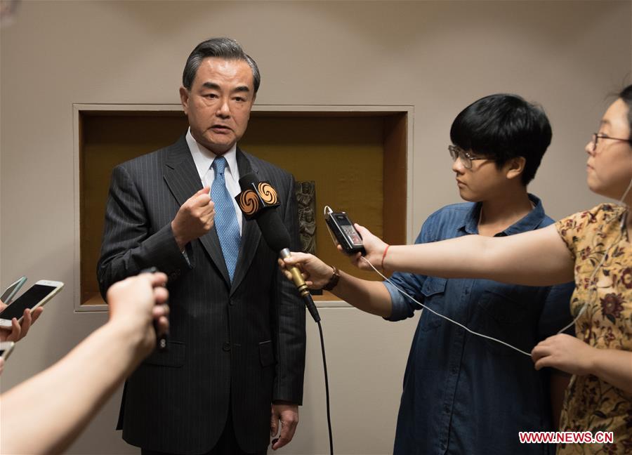 Chinese Foreign Minister Wang Yi (L) receives interviews in New Delhi, capital of India, on Aug. 13, 2016. Wang Yi said here Saturday that consensus had been reached with the Indian side to firmly support each other so as to ensure the successful organization of the upcoming G20 and BRICS summits. (Xinhua/Bi Xiaoyang)