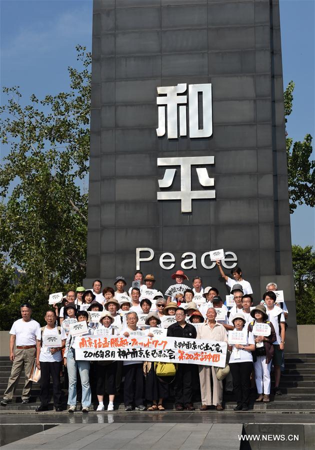 Delegates from China, South Korea and Japan pose for photos during an assembly at the Memorial Hall of the Victims in Nanjing Massacre by Japanese Invaders in Nanjing, capital of east China