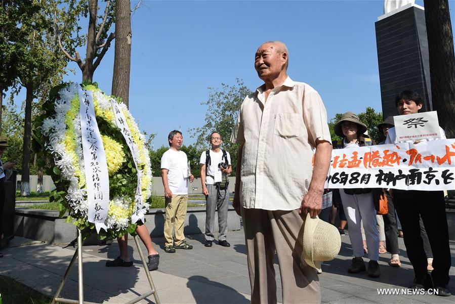 A survivor of Nanjing Massacre pays tribute to victims during an assembly at the Memorial Hall of the Victims in Nanjing Massacre by Japanese Invaders in Nanjing, capital of east China