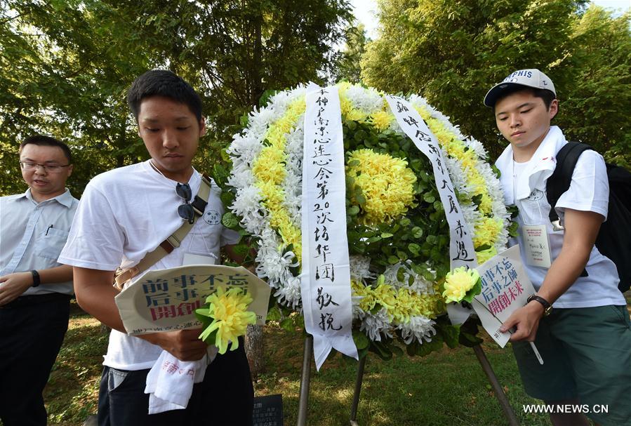 Delegates from Japan present a wreath to victims of the Nanjing Massacre during an assembly at the Memorial Hall of the Victims in Nanjing Massacre by Japanese Invaders in Nanjing, capital of east China