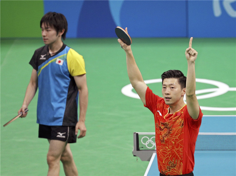 Ma Long of China gestures after winning his match against Koki Niwa of Japan in men