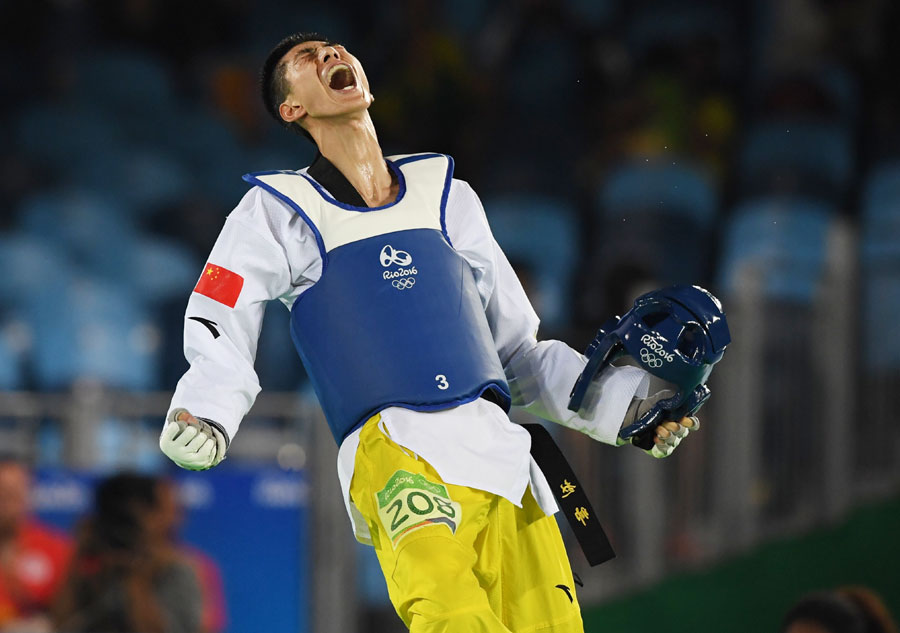 Zhao Shuai of China celebrates after winning taekwondo men