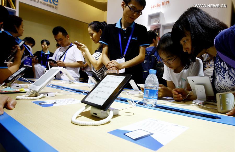 People experience e-books at Shanghai Book Fair in east China