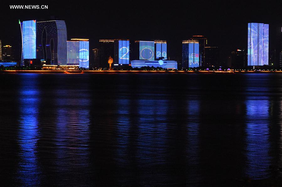 Photo taken on Aug. 27, 2016 shows buildings along Qiantang River are illuminated with the G20 logo in Hangzhou, capital of east China