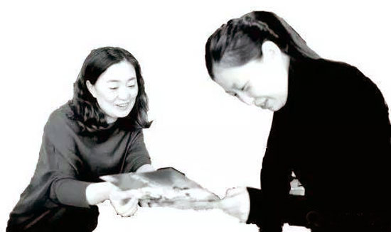 王慶（左）在給顧客介紹旅遊項目