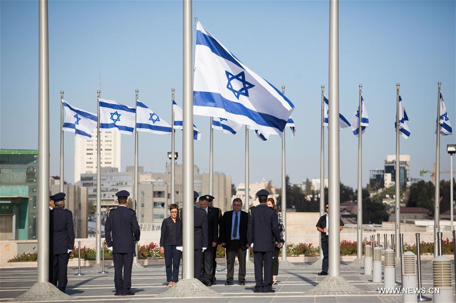 Members of Knesset Honor Guard lower the Israeli flag at half-mast during a ceremony in memory of former Israeli President Shimon Peres at the Knesset, the Israeli parliament in Jerusalem, Sept. 28, 2016. Israel