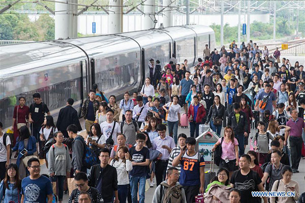 Passengers walk out of the Nanjing Railway Station in Nanjing, capital of East China