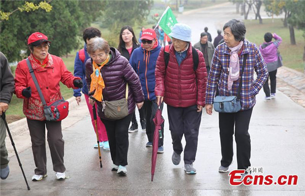 Double Ninth Festival is also called "Mountain-climbing Festival". Elderly people climb a mountain on Chinese traditional Double Ninth Festival in Beijing Xishan National Forest Park on Oct 21, 2015. [Photo/China News Service]