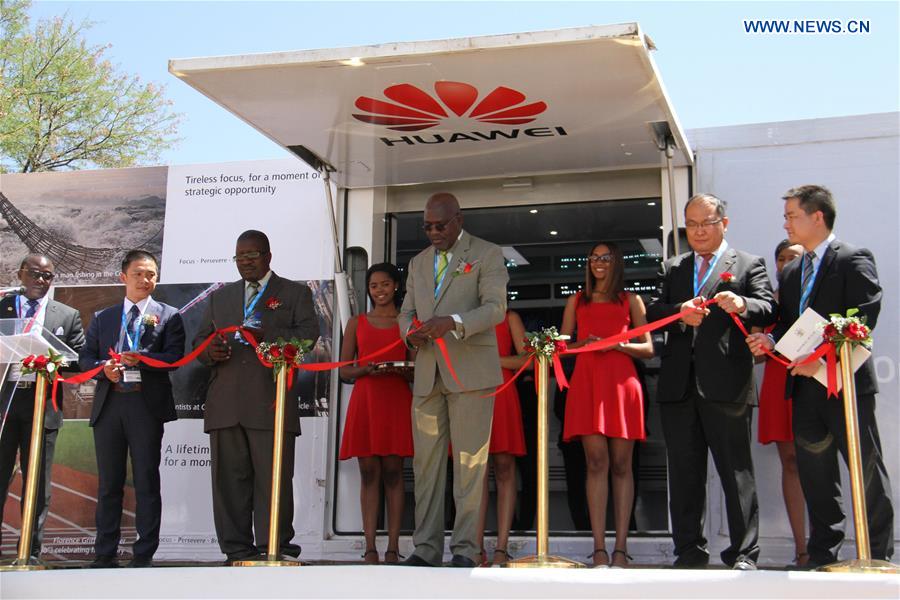 Namibian information minister Tjekero Tweya (C) cuts the ribbon for Huawei Demo Truck during the official opening of the 2016 ICT summit, in Windhoek, Namibia, on Oct. 10, 2016. China