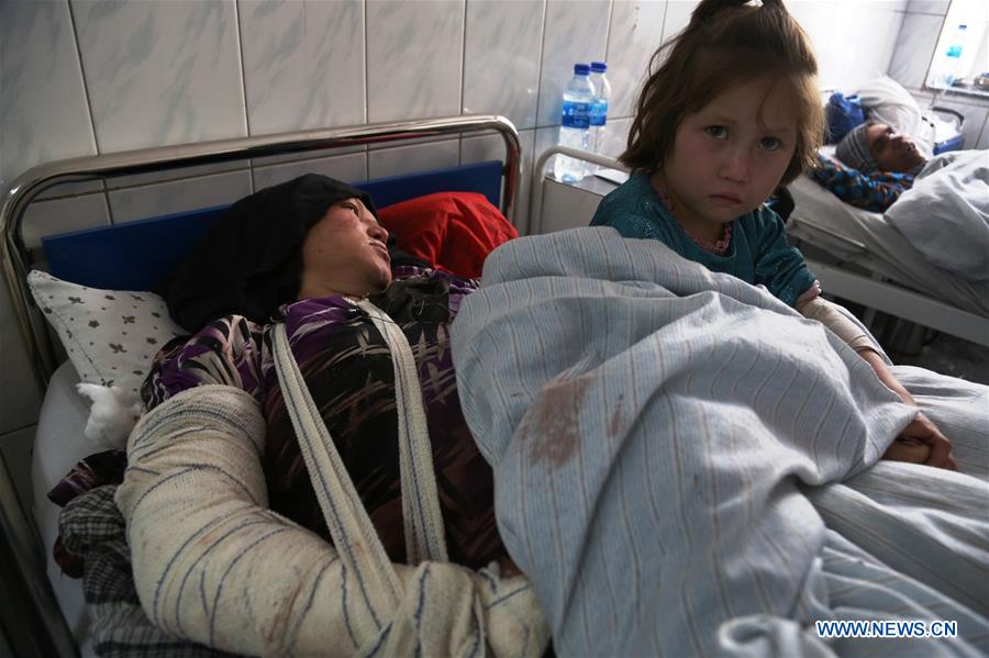 An injured woman and her child receive medical treatment at a hospital in Kabul, capital of Afghanistan, Oct. 12, 2016. At least 14 people were killed and over 40 others injured Tuesday night after gunmen attacked a shrine in Kabul, where hundreds of mourners were observing Ashura rituals during the Muslim holy month of Maharram.(Xinhua/Rahmat Alizadah) 